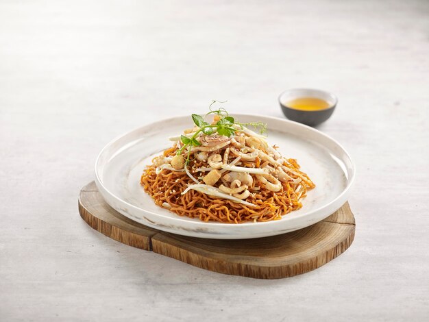 Stirfried Noodle with Pork Lard and Squid in Supreme Soya Sauce served in a dish side view on grey background