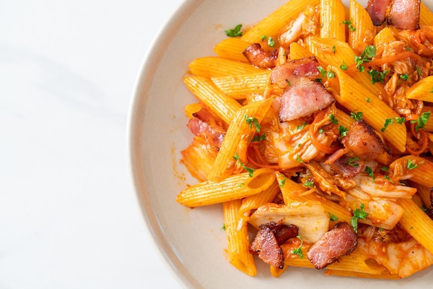 Stirfried penne pasta with kimchi and bacon