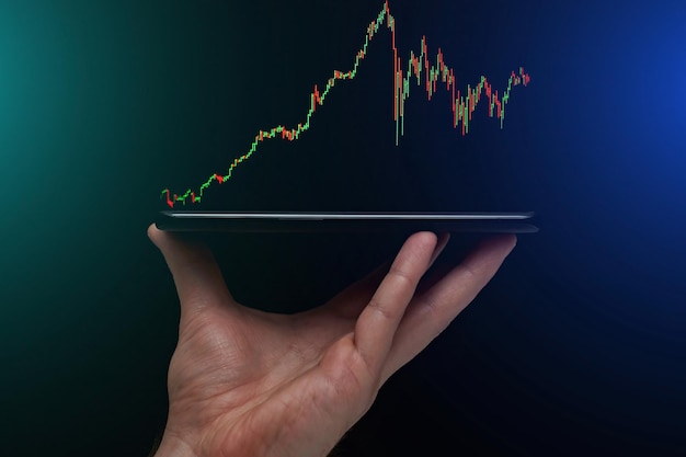 Stock market, Business growth, progress or success concept. Hand of Businessman or trader is showing a growing virtual hologram stock on smartphone