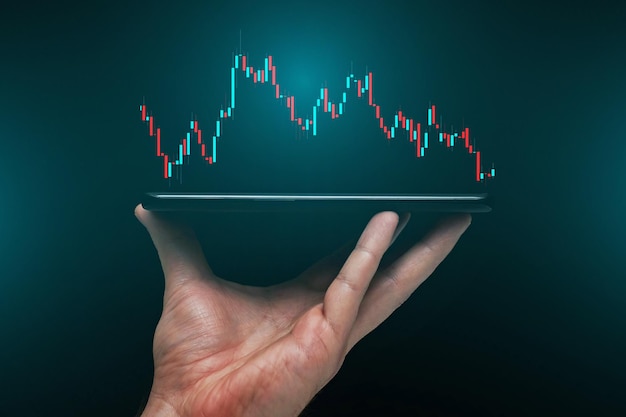 Stock market, Business growth, progress or success concept. Hand of Businessman or trader is showing a growing virtual hologram stock on smartphone