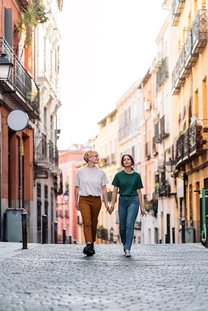 Stock photo of Lesbian couple loving. They are walking together. They are on a date. Urban concept.