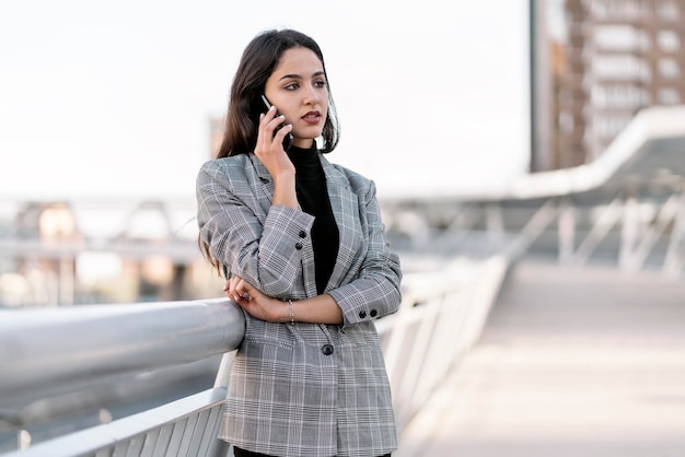 Stock photo of a young business woman having a conversation on the phone She is smiling