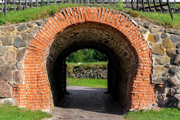 Stone arch and tunnel in the fortress wall Vintage building background