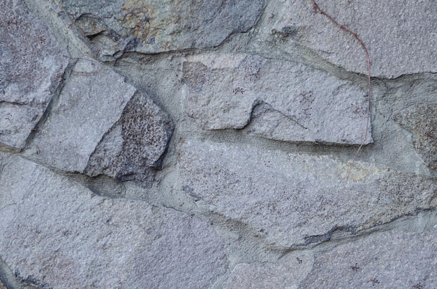 Stone background wall of natural stone on the whole frame