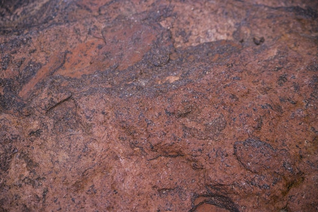 Stone brown textured background Natural stone Uneven surface The surface is covered with rust