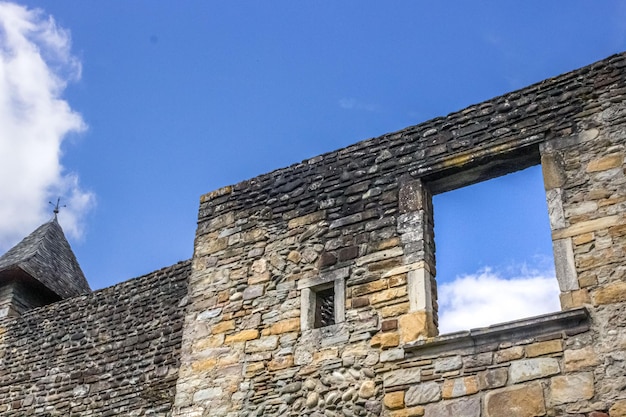 A stone building with a window that is open to the sky