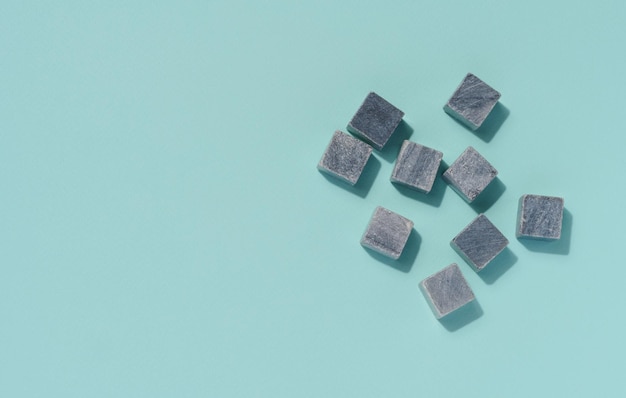 Stone cocktail cubes on a blue background top view stone cocktail cubes blue background top view