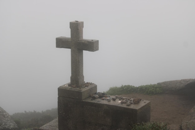 Stone cross at the end of the St James way in Cape Finisterre