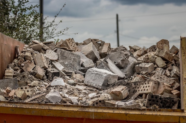 Stone dump on the ruins of a private house. A pile of construction debris and stones.