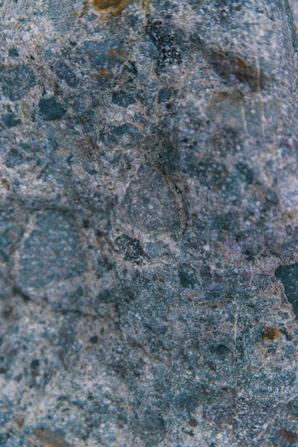 Stone grayblue textured background Natural stone The black background is a blank for the design Uneven surface