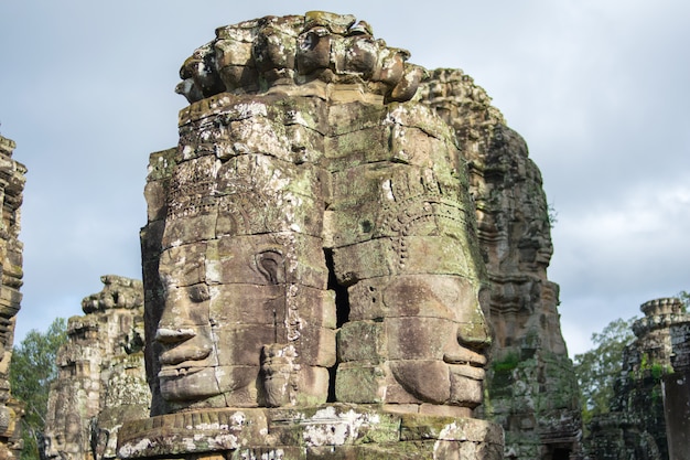 Stone head on towers of Bayon temple in Angkor Thom, Cambodia