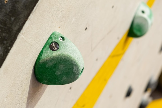 Stone hooks or grips on the artificial climbing wall in bouldering gym