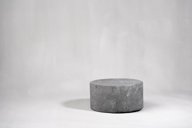 a stone is placed in front of a white background with a small object on it