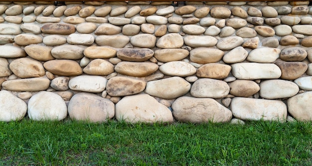 Stone laying of an old wall on to grass