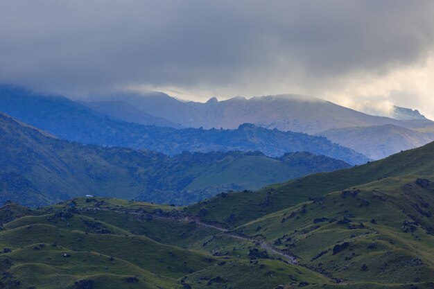 Stone ledge of a rocky ridge against the blue sky. Caucasian mountain range in Russia.