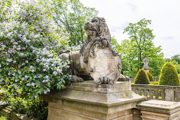 Stone lion statue with a coat of arms near the Ksiaz Castle. Walbrzych, Poland