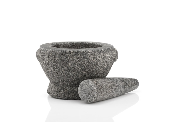 Stone mortar and pestle on white