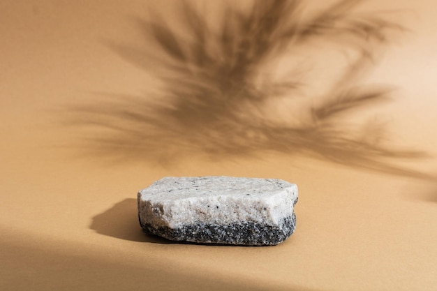 Stone podium with two colors on beige background with shadows mockup