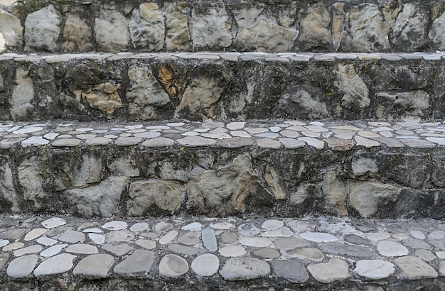 Stone staircase in a private house on the street From black granite With white railings