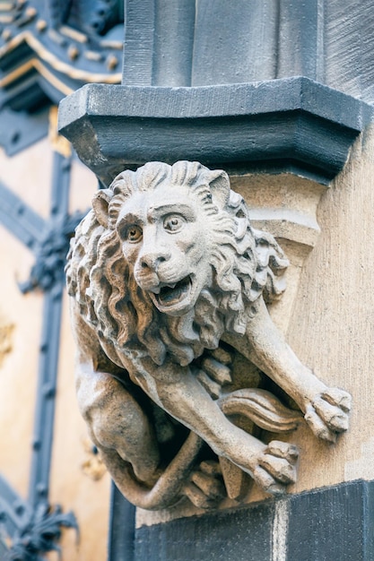 Stone statue lion at the facade of New City Hall in Munich Germany Details