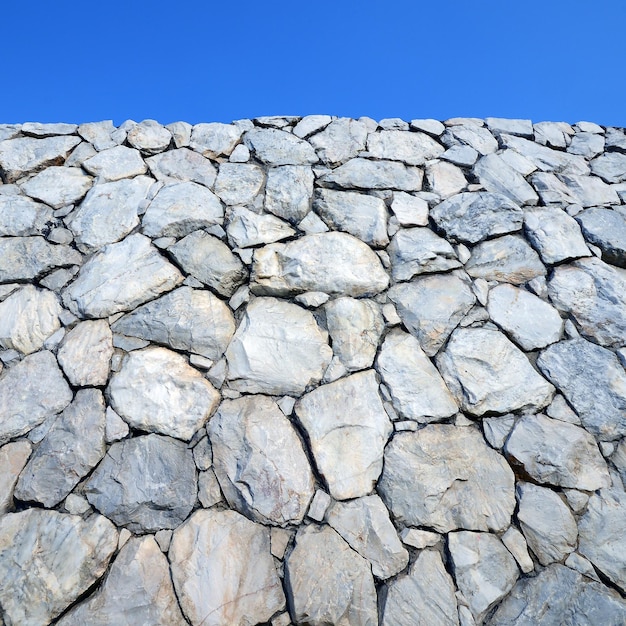 Stone wall background and texture with blue sky