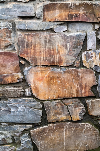 Stone wall Closeup wall of hewn wild stone Stone background