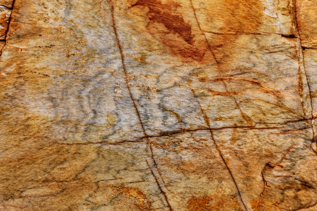 Stone wall granite natural surface texture. Structural surface close-up.