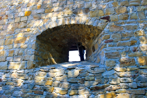 Stone wall of a stronghold with embrasure