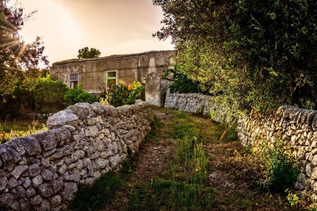 a stone wall with a door that says  the entrance to a building