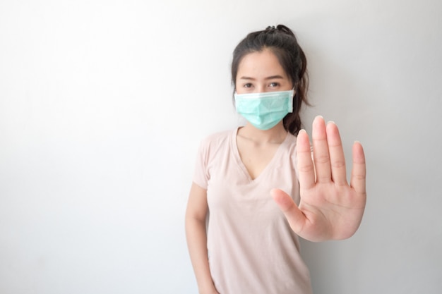 Stop the infection! Healthy woman showing gesture 