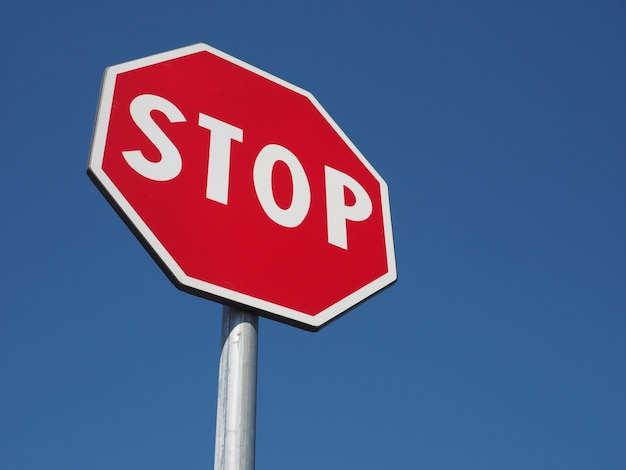 Stop sign over blue sky