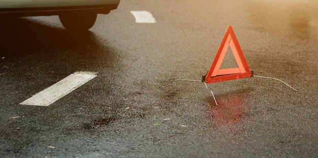 Stop sign and broken car on the road