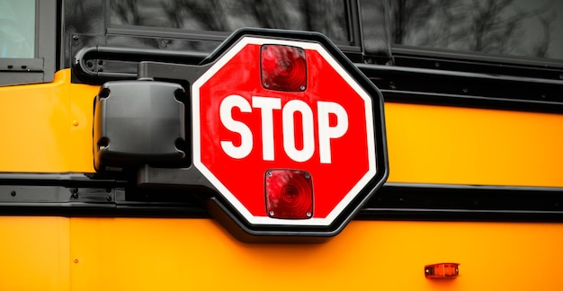 A stop sign is mounted on a yellow vehicle.