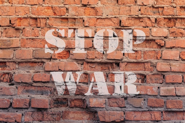 Stop war text on brick wall