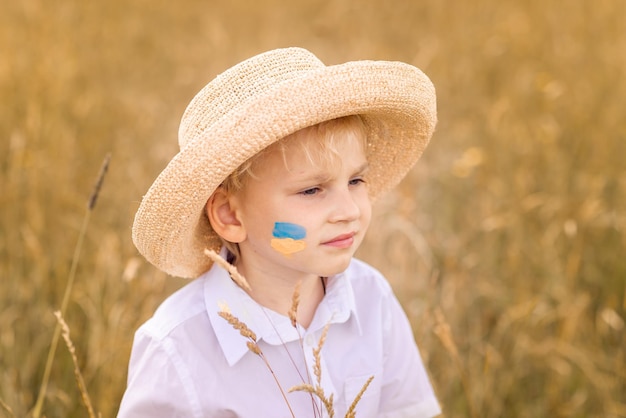 Stop War in Ukraine Ukrainian boy with Ukrainina flag yellow and blue stands against war