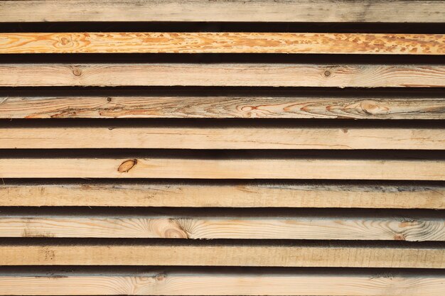 Photo storage timber. lumber yard. stock of timber wood construction in warehouse.planks of wood stacked neatly on the shelves in the hardware store.