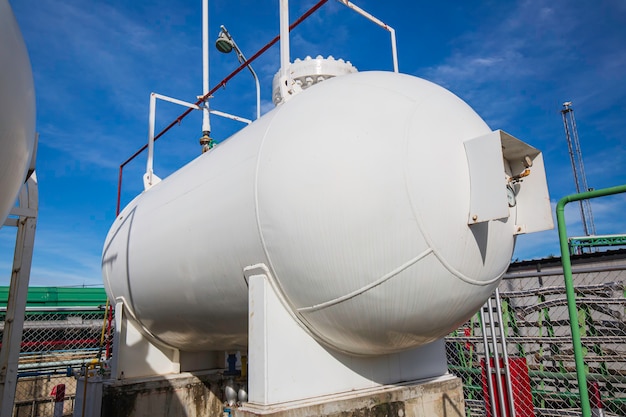 Storage two of gas LPG in the horizontal white tank's blue sky.