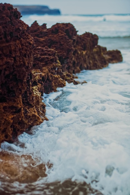 Storm in the ocean sea waves crashing on rocks on the beach coast nature and waterscape