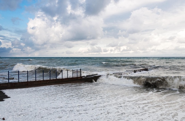 Storm waves roll on the breakwater