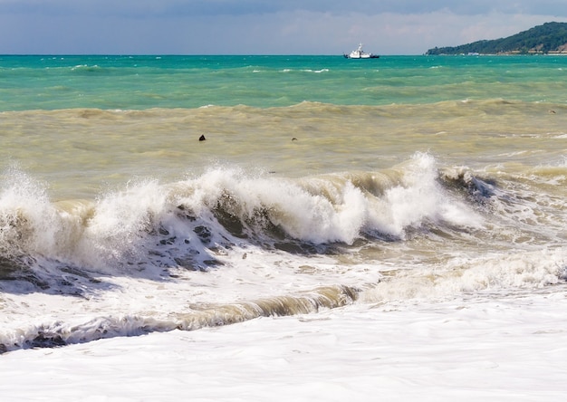 Storm waves on the sea shallows. Stormy weather.