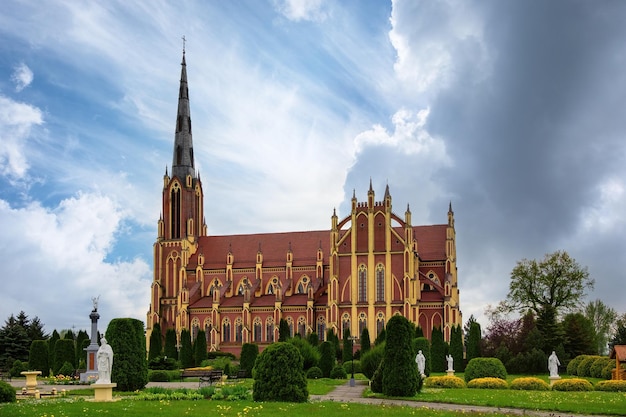 Stormy clouds over Holy Trinity Catholic Church in Gothic Revival style in the agrotown Gervyaty Grodno region Belarus