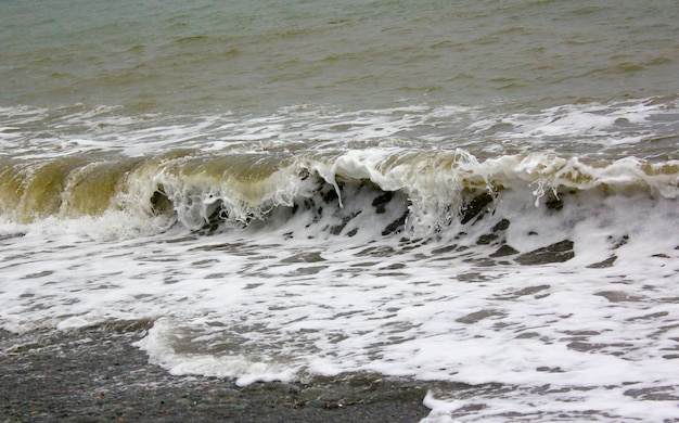 Stormy seascape, waves and wind in the black sea of Georgia. Drops ans splashes.