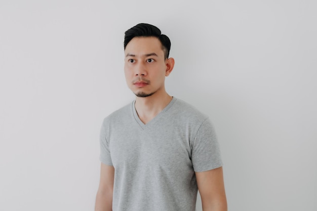 Straight face portrait of serious asian man in grey tshirt