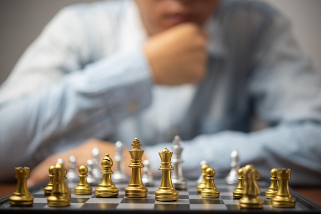 Strategic planning and goals success business idea Businessman looking at chess at the board