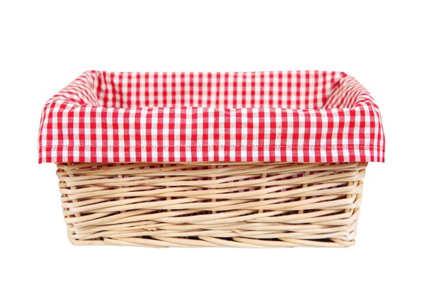 Straw basket with red checkered picnic cloth isolated