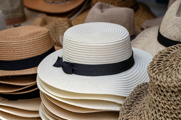 Straw hats on display for sale to tourists on street local market in Ubud island Bali Indonesia closeup