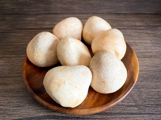 Straw mushroom in the wooden plate on the table