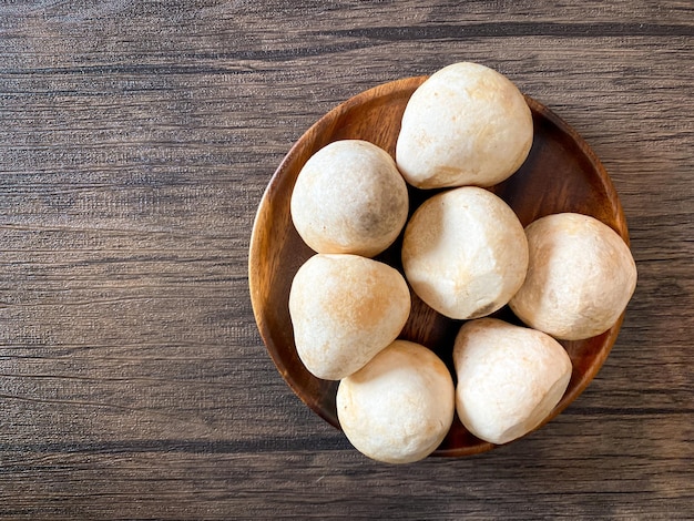 Straw mushroom in the wooden plate on the table