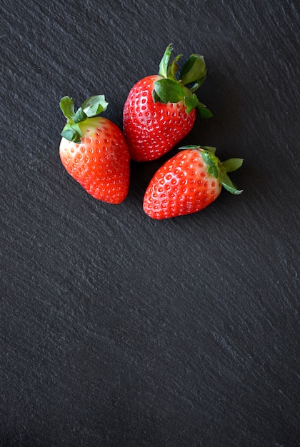 Strawberries on a black slate table ready to be used