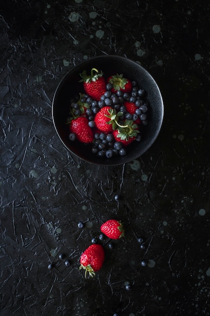 Strawberries and blueberries, food on a black background